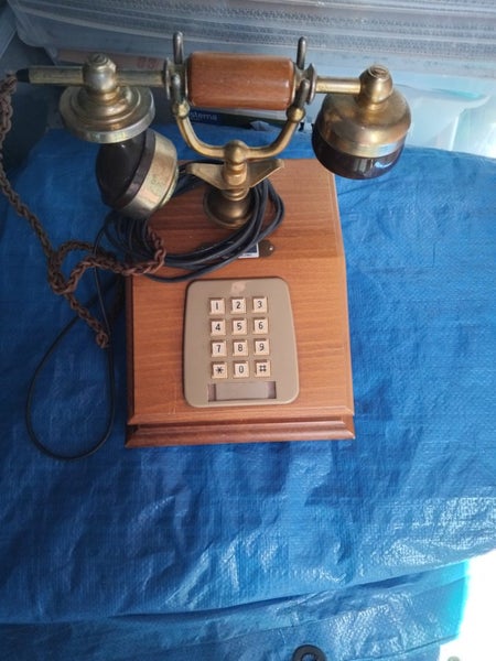 An old rotary design landline phone with buttons. Carousel 2