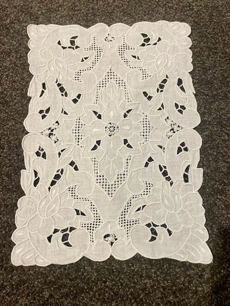 A lovely white worked linen Doily Carousel 1