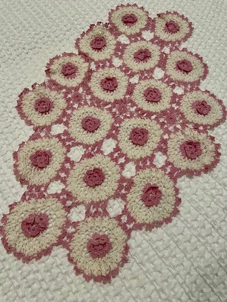 A lovely hand crocheted pink & white doily with raised flowers Carousel 1