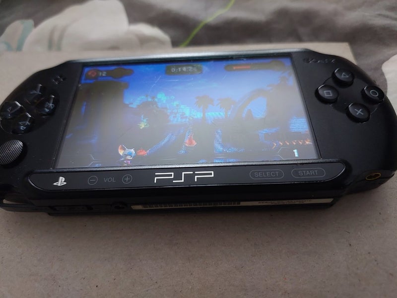 PSP, original charger, 4GB storage card and 9 Games Carousel 1