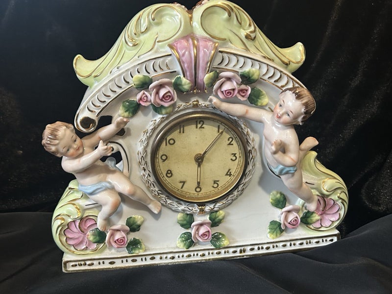 Vintage clock Porcelain Mantle Clock decorated with cherubs and floral motifs Carousel 1