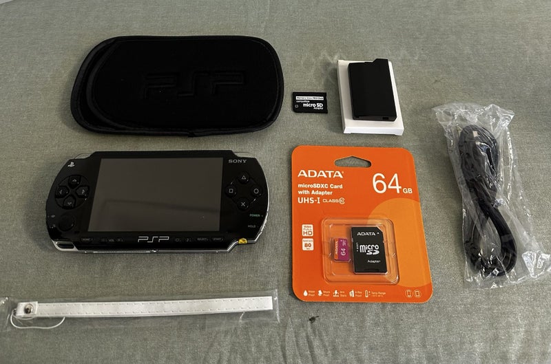PSP 1000 – Piano Black | 64GB | Fully Set Up64142344263681110
