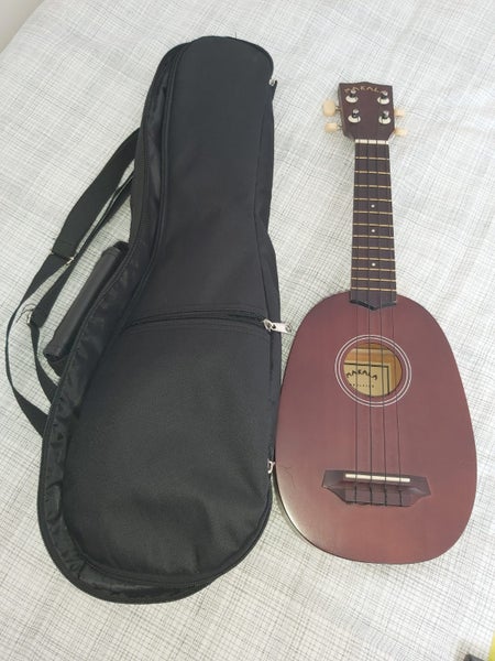 Ukelele, case, and tuner Carousel 1