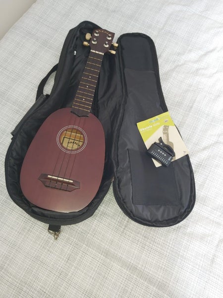 Ukelele, case, and tuner Carousel 2