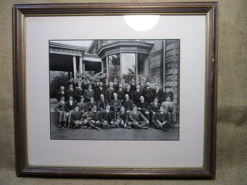 Old group photo, framed behind glass. Islanders or Maoris plus a few pakehas. Carousel 2