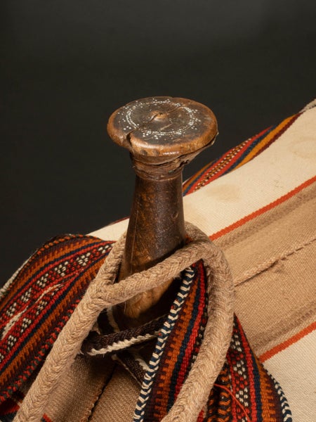 Camel saddle. Wood, hide thongs. Hand-woven trappings. Carousel 2
