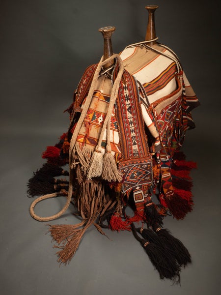 Camel saddle. Wood, hide thongs. Hand-woven trappings. Carousel 1