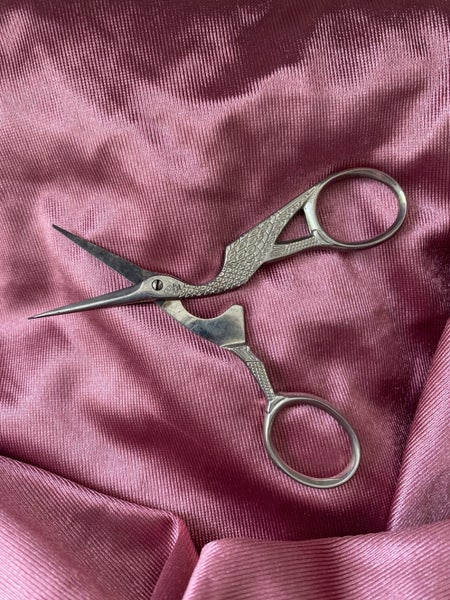 pair of stork embroidery scissors, a common tool in sewing and needlework. Carousel 2
