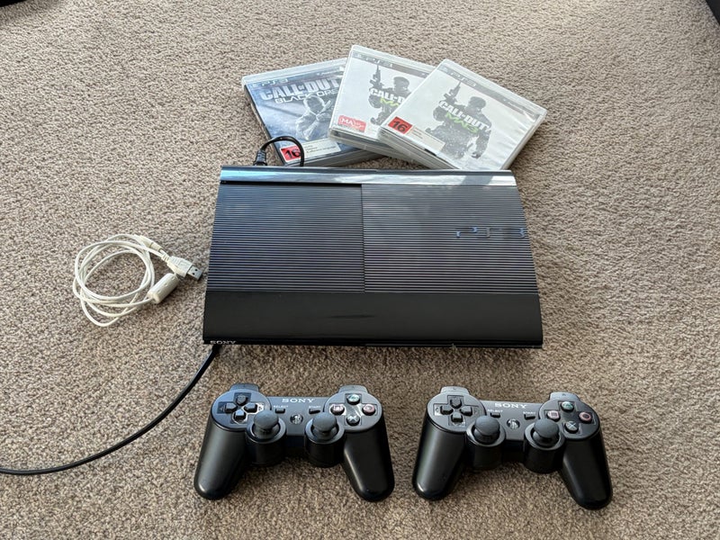 PS3 Super Slim 500 GB, Dual Shock Controllers, Games Carousel 1