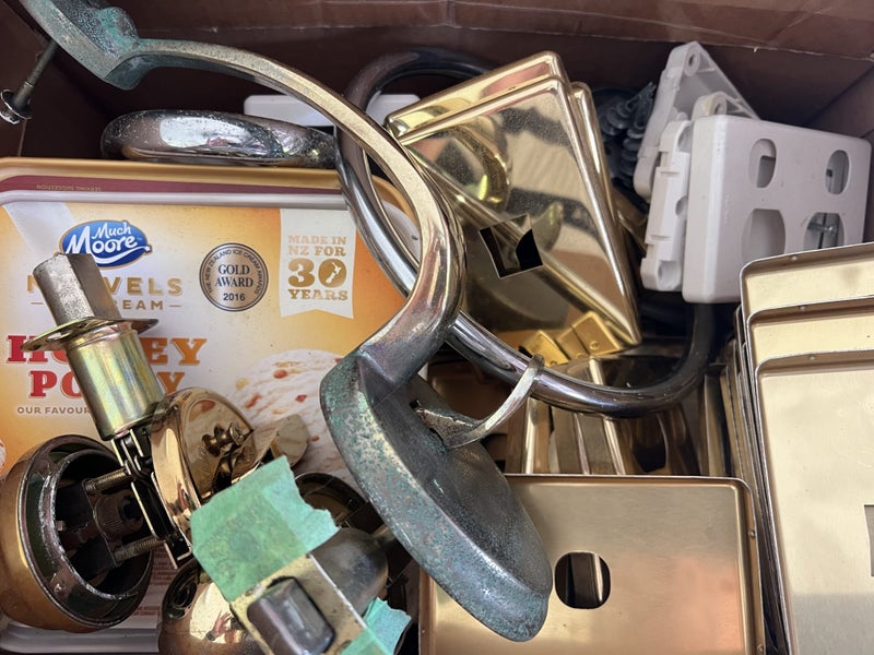 Box of gold door knobs and light switch covers Carousel 3