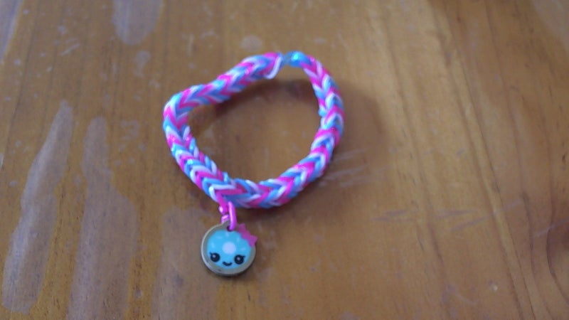Pink, blue and white loom band bracelet with doughnut charm Carousel 1