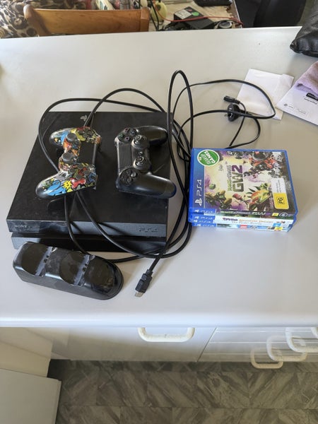PS4, 2 controllers , charging port and 5 games Carousel 1