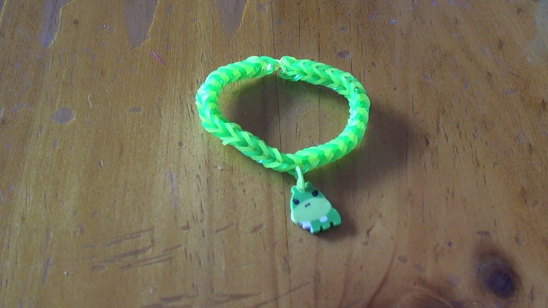 Green and yellow loom band bracelet with hippo charm Carousel 1