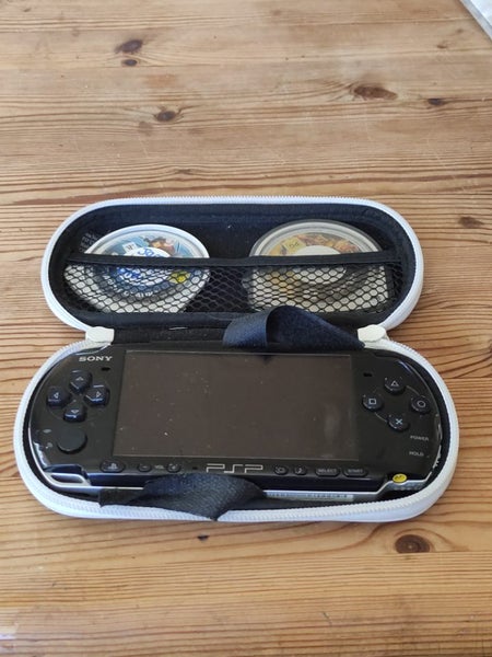 Working PSP 2002 Slim (with charger), four games and a case. Carousel 1