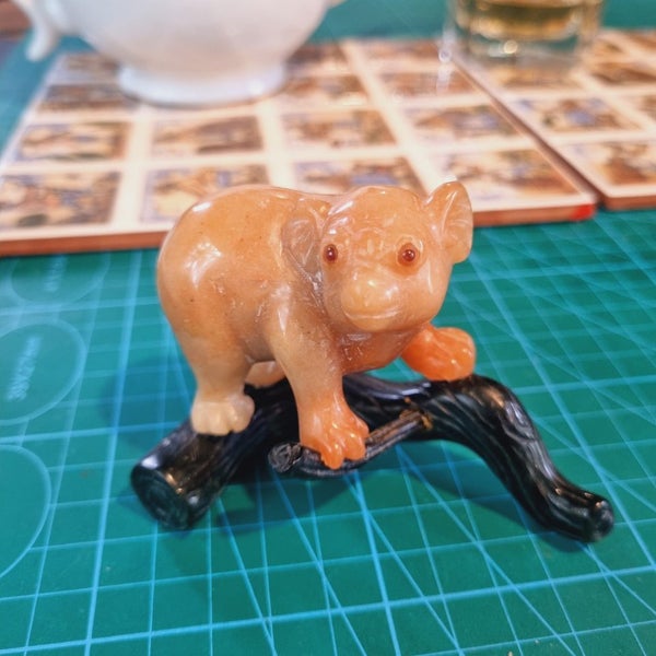 An orange Jasper jade bear on dark green jade branch Carousel 1