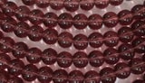 A STRAND OF 8 mm PURPLE GLASS BEADS
