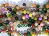 A STRAND of 10mm MIXED GEMSTONE BEADS
