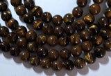 A STRAND of 10mm TIGER EYE GEMSTONE BEADS