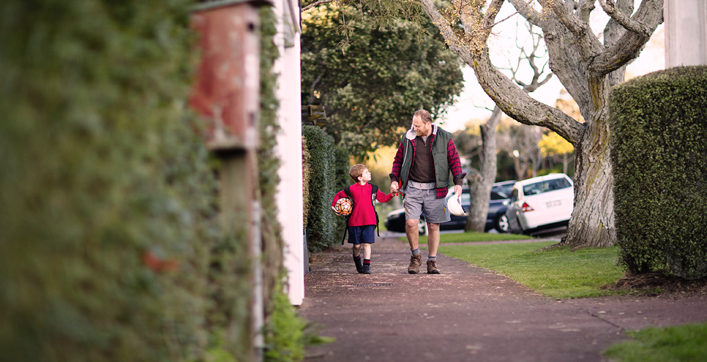 Father and son walking to school together.
