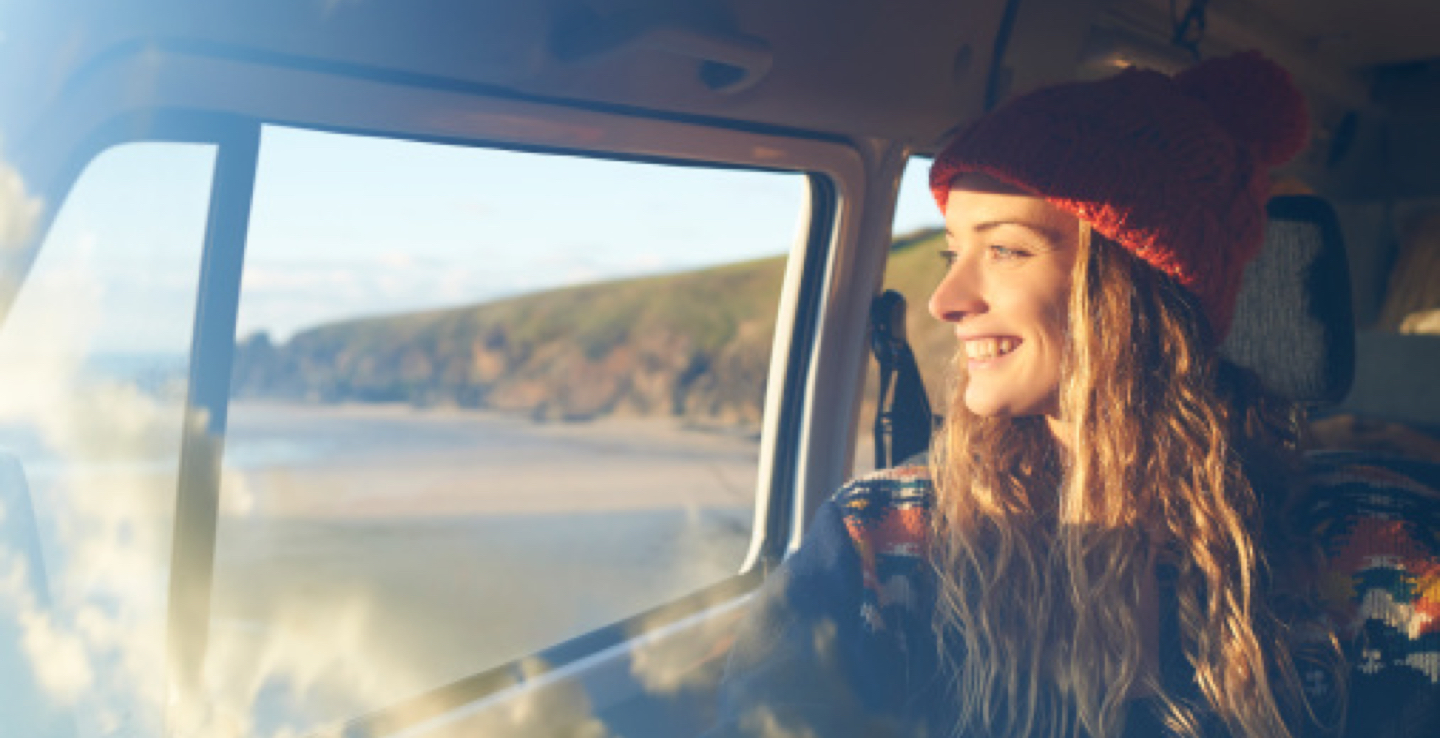 A women looking out the window of her car.